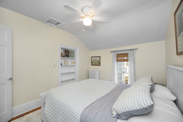 bedroom featuring ceiling fan, radiator heating unit, and vaulted ceiling