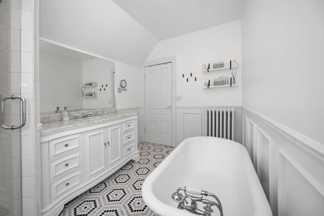 bathroom featuring radiator heating unit, vanity, lofted ceiling, and shower with separate bathtub