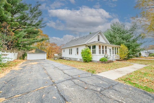 view of side of home featuring a garage and an outdoor structure