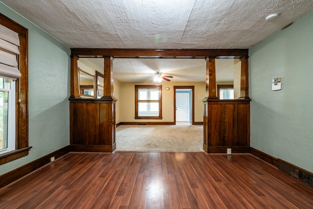 spare room featuring ceiling fan, dark hardwood / wood-style flooring, and a textured ceiling