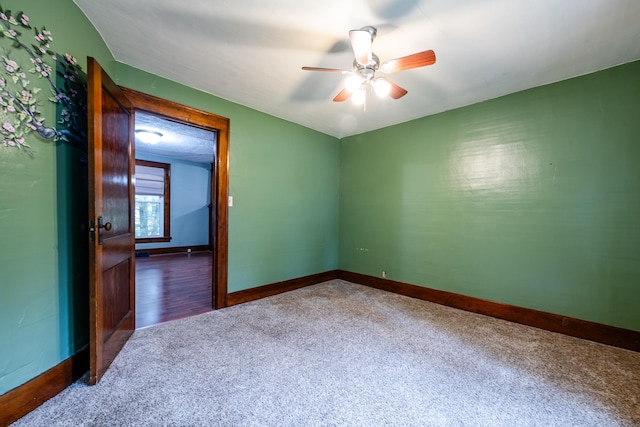 carpeted empty room with ceiling fan