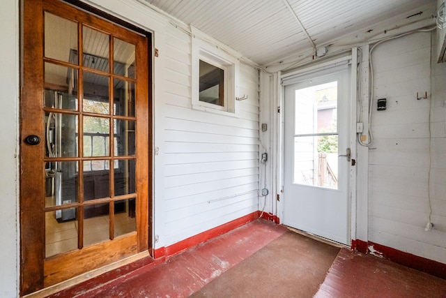 doorway featuring wooden walls