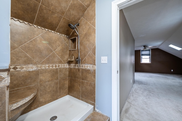 bathroom featuring tiled shower, ceiling fan, and lofted ceiling