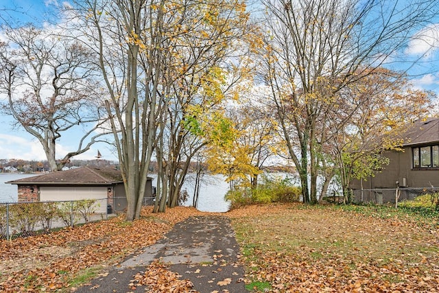 view of yard with a garage and a water view