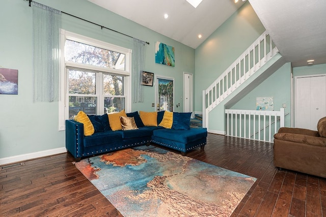 living room featuring lofted ceiling and dark hardwood / wood-style floors