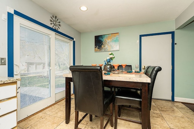 tiled dining room with plenty of natural light