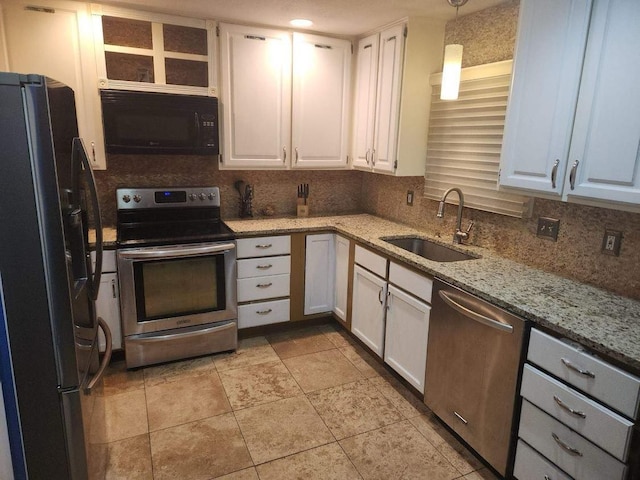 kitchen featuring black appliances, white cabinetry, decorative light fixtures, and sink