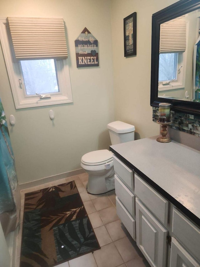 bathroom with vanity, tile patterned flooring, and toilet