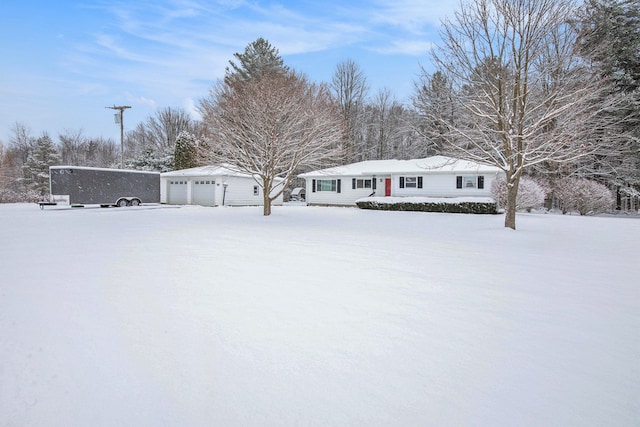 view of front of property featuring a garage and an outbuilding