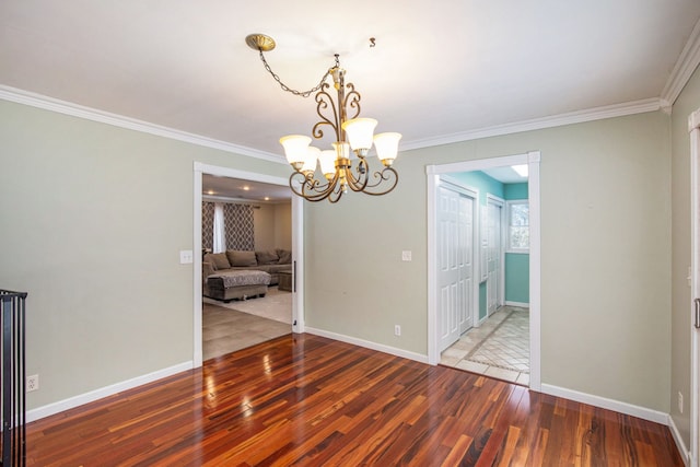 unfurnished dining area with a chandelier, hardwood / wood-style flooring, and crown molding