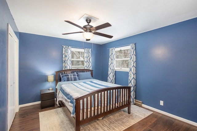 bedroom with ceiling fan, dark hardwood / wood-style floors, and a closet