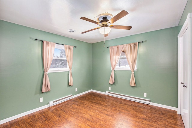 empty room with ceiling fan, wood-type flooring, and a baseboard radiator