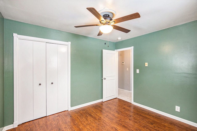 unfurnished bedroom featuring a closet, ceiling fan, and dark hardwood / wood-style floors