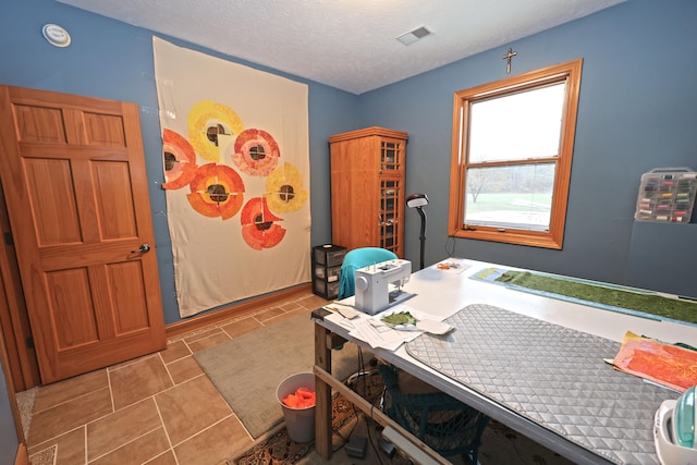 tiled home office featuring a textured ceiling