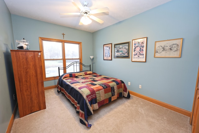 bedroom with ceiling fan and light carpet