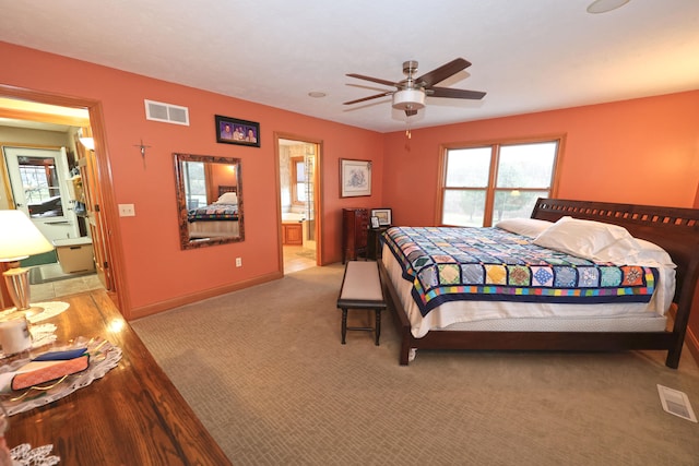 bedroom with ensuite bath, ceiling fan, and light carpet