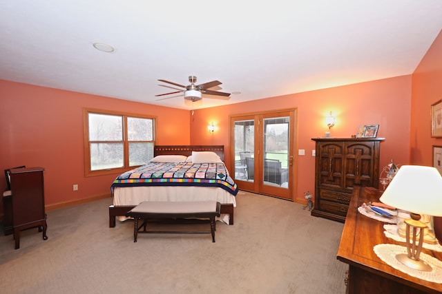 carpeted bedroom with access to exterior, multiple windows, and ceiling fan