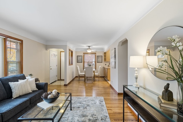 living room featuring ceiling fan and light hardwood / wood-style floors