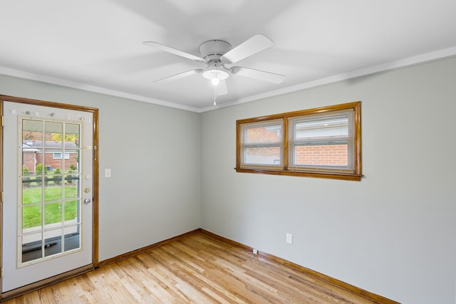 empty room featuring light hardwood / wood-style floors, ceiling fan, and crown molding