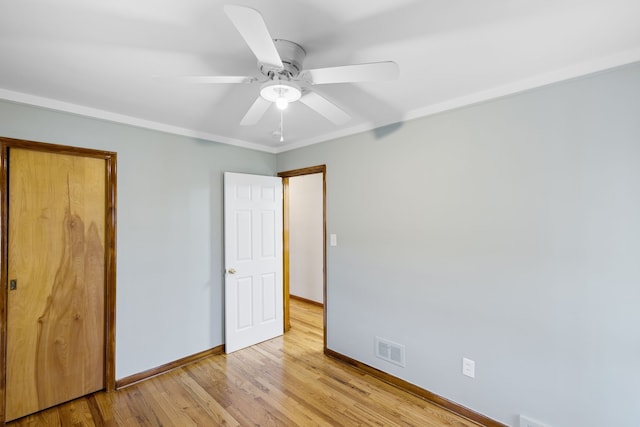 unfurnished bedroom featuring a closet, light hardwood / wood-style floors, and ceiling fan