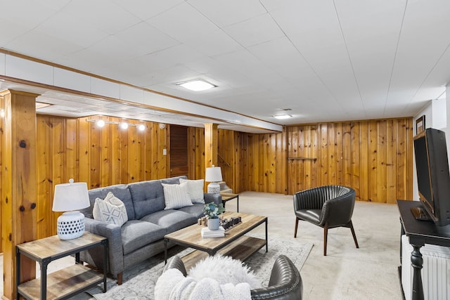 living room featuring radiator, wooden walls, and light colored carpet