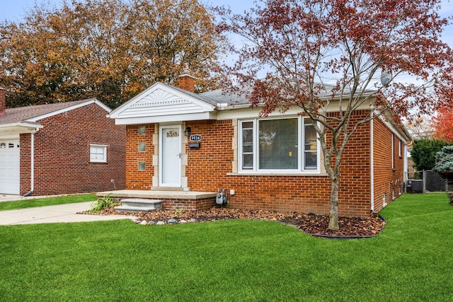 view of front of house with a front yard and a garage