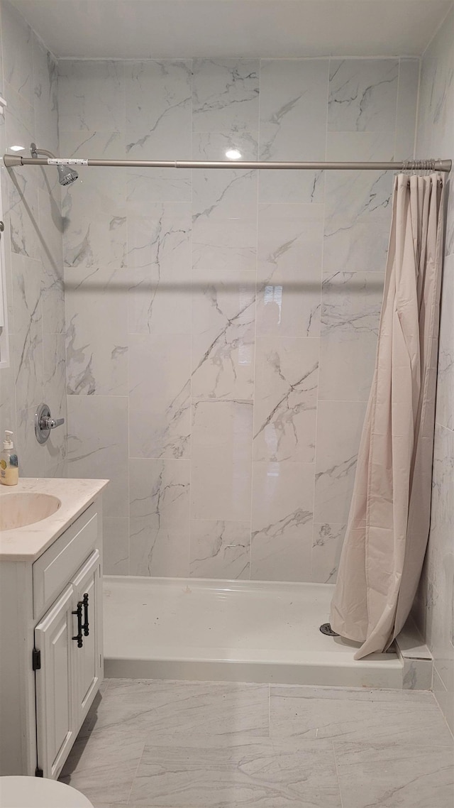 931 Hughes Ave, Flint, MI 48503 - full bathroom featuring a shower stall, vanity, and marble finish floors