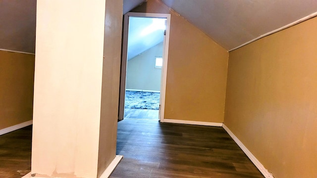 additional living space featuring dark hardwood / wood-style flooring and vaulted ceiling