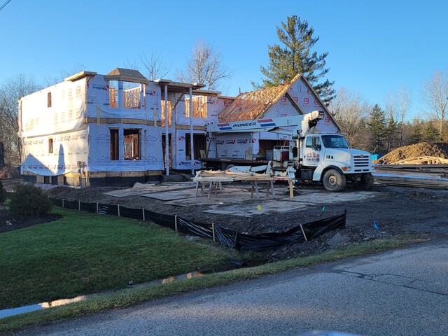 rear view of property featuring a yard