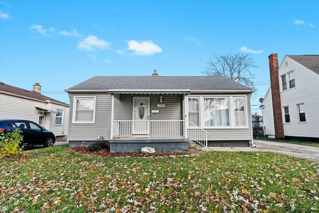 bungalow-style home with a front lawn