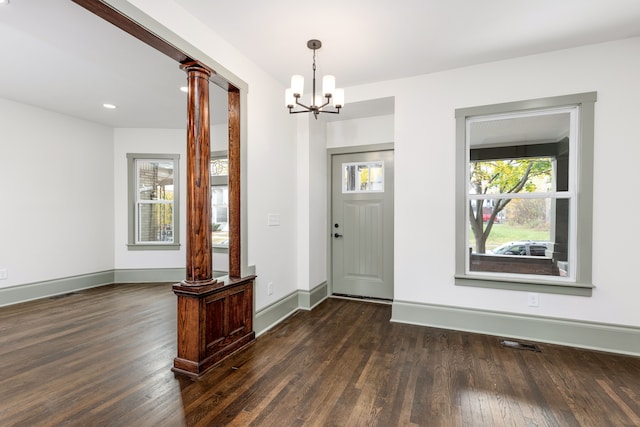 entrance foyer featuring dark hardwood / wood-style floors and an inviting chandelier