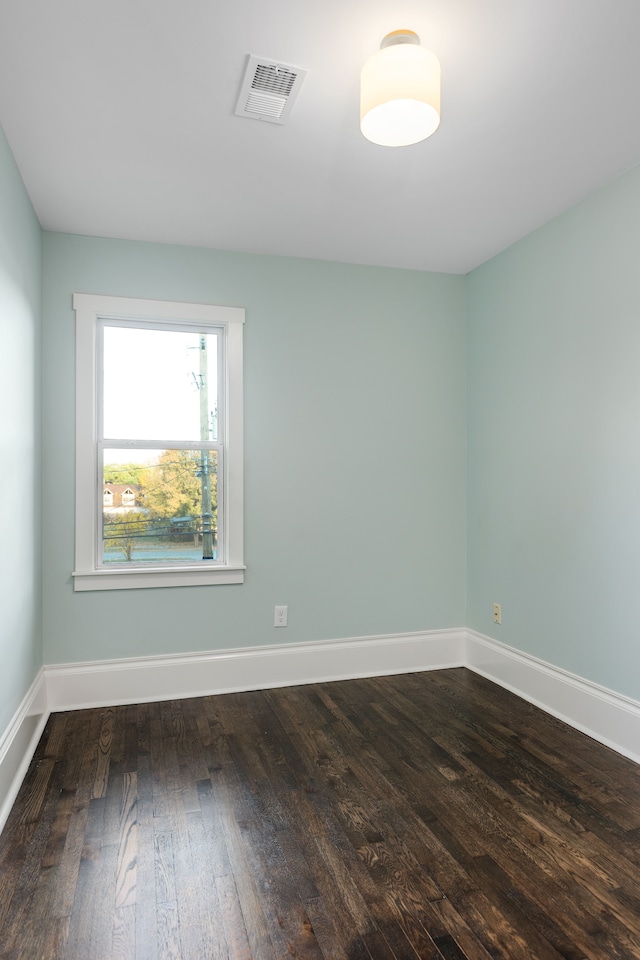 unfurnished room with dark hardwood / wood-style floors