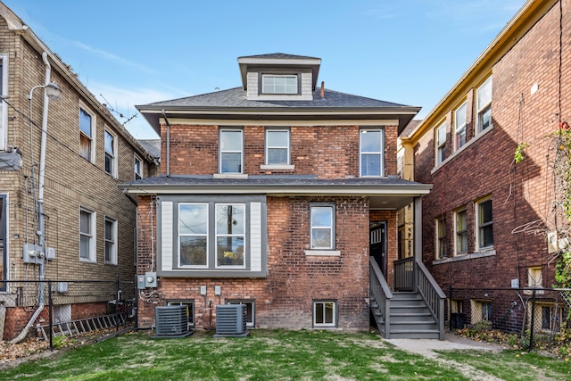 view of front of property featuring central AC unit and a front lawn