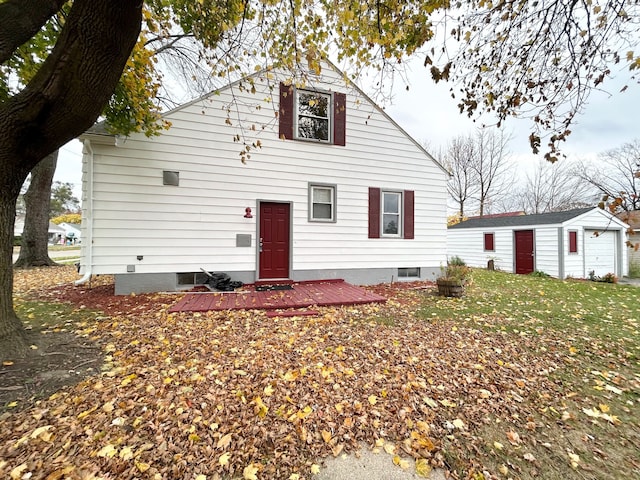 view of front of home with a wooden deck, a front lawn, and an outdoor structure