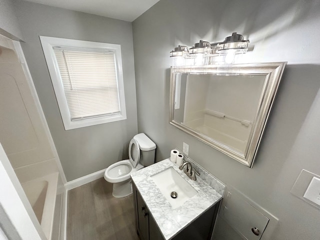 bathroom featuring hardwood / wood-style floors, vanity, and toilet