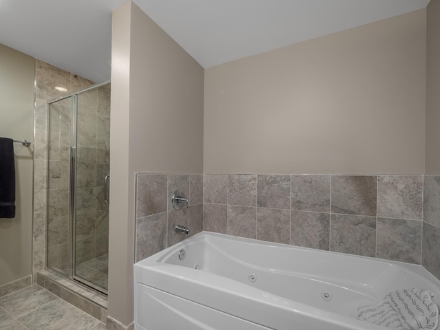 bathroom with tile patterned floors and a washtub