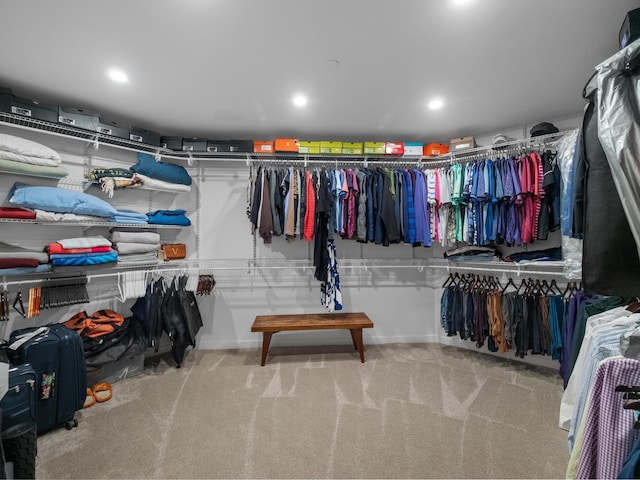 walk in closet featuring light colored carpet