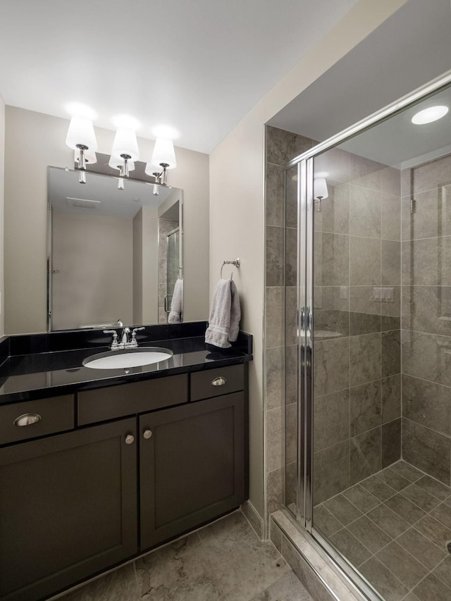 bathroom featuring vanity and a shower with shower door