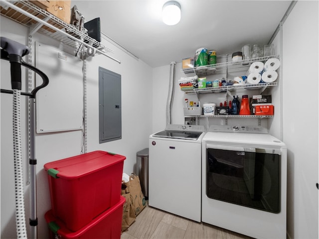 clothes washing area featuring separate washer and dryer and electric panel