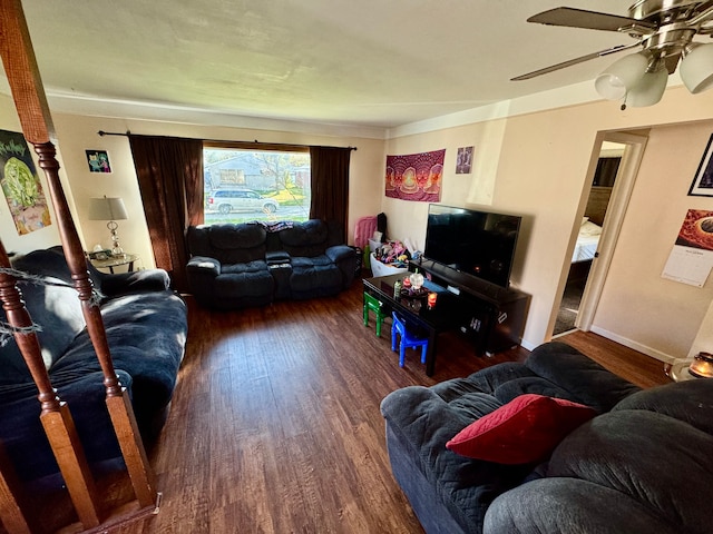 living room featuring ceiling fan and dark hardwood / wood-style flooring