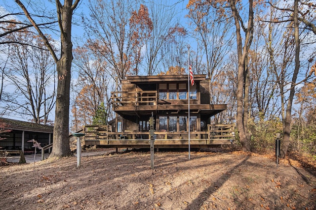 back of house featuring a wooden deck