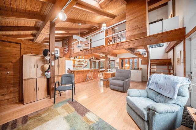 living room with beam ceiling, wood ceiling, and light wood-type flooring