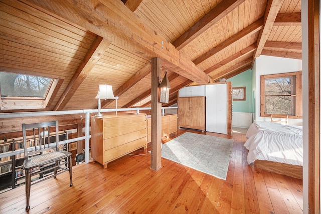 bedroom with hardwood / wood-style floors, lofted ceiling with skylight, and wooden ceiling