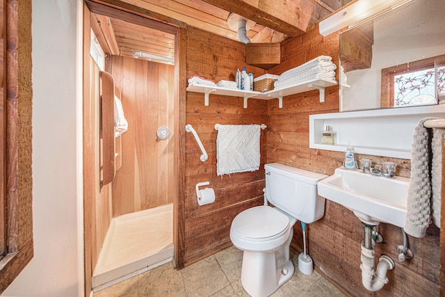 bathroom featuring tile patterned floors, toilet, and wooden walls