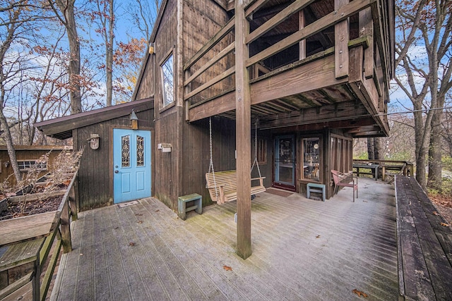 view of exterior entry featuring a wooden deck and french doors