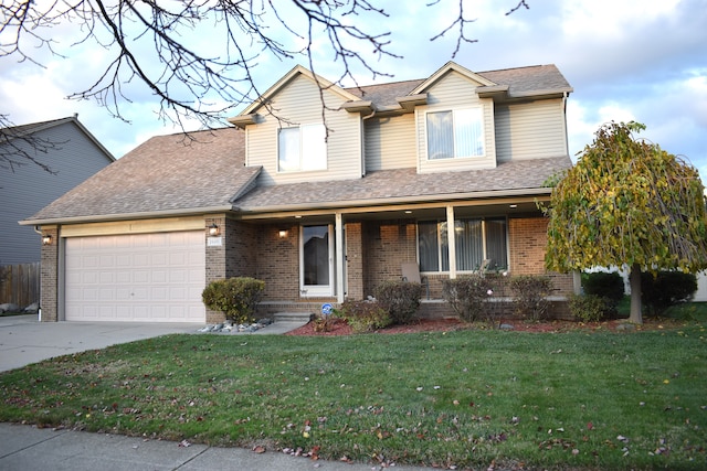 view of front of house with a front yard and a garage