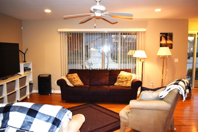 living room featuring ceiling fan and hardwood / wood-style flooring