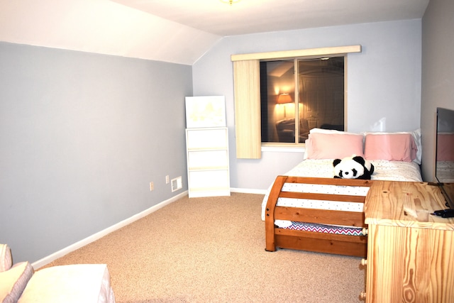 carpeted bedroom with lofted ceiling and a closet