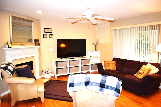 living room with ceiling fan and light hardwood / wood-style floors