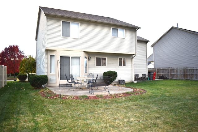 rear view of house with a lawn and a patio area